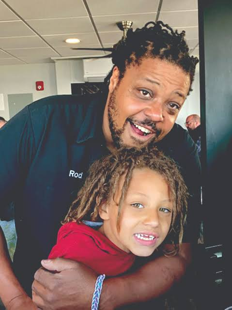 Rod Cornish hugging a smiling child